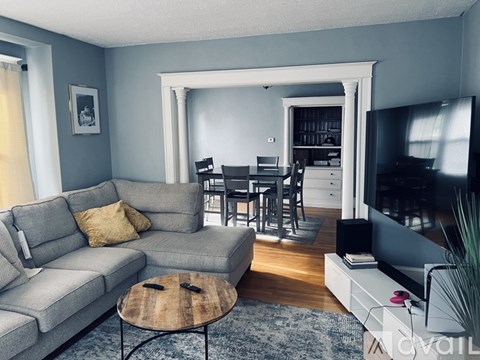 A living room with a grey couch and a coffee table.