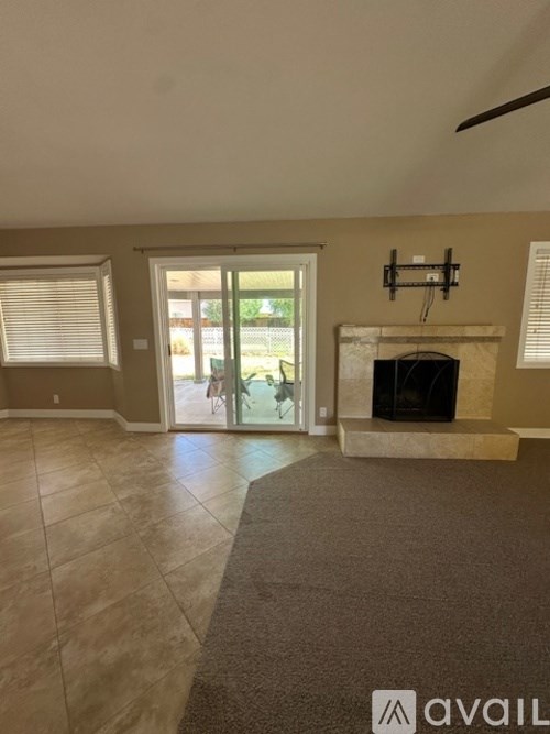 A living room with a fireplace and sliding glass doors.