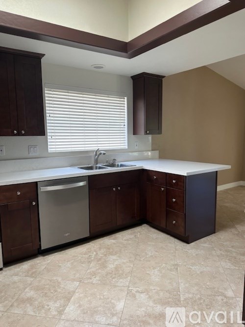 A kitchen with brown cabinets and a white countertop.
