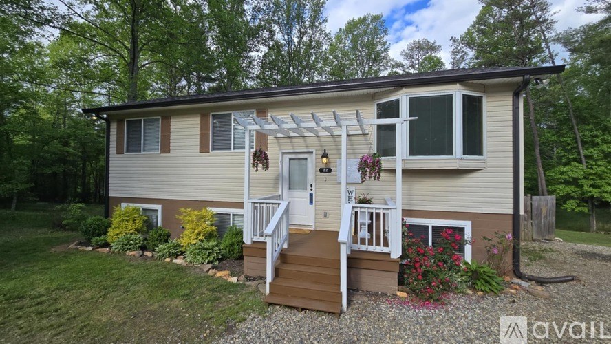 A house with a porch and a white door is for sale.