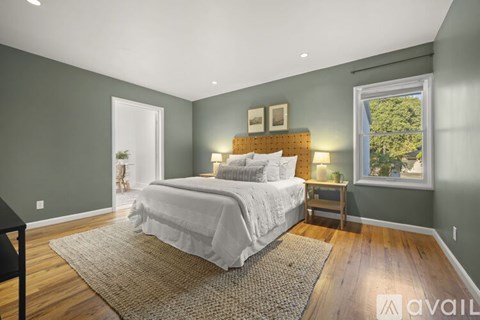 A bedroom with a large bed and a window.