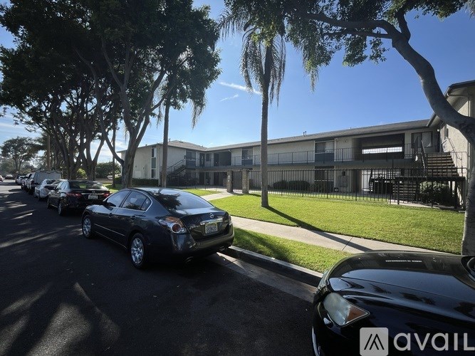 A black car is parked on the side of a street.