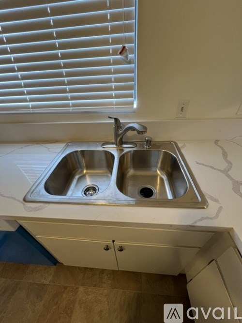 A kitchen sink with a faucet and a countertop.