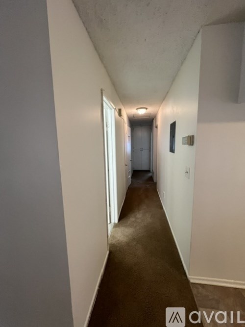 A long hallway with a door at the end.