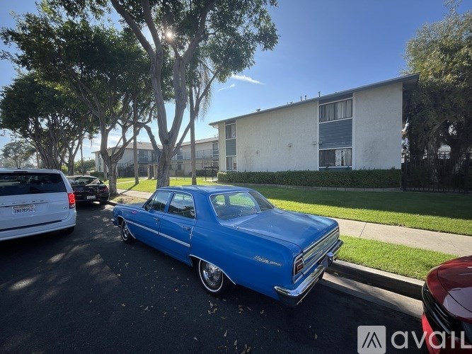 A blue vintage car is parked on the street.