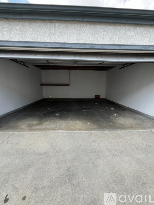A spacious garage with a concrete floor and white walls.