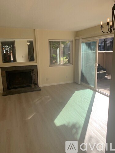 A living room with a fireplace and sliding glass doors.