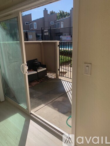 A patio with a table and chairs is visible through a glass door.