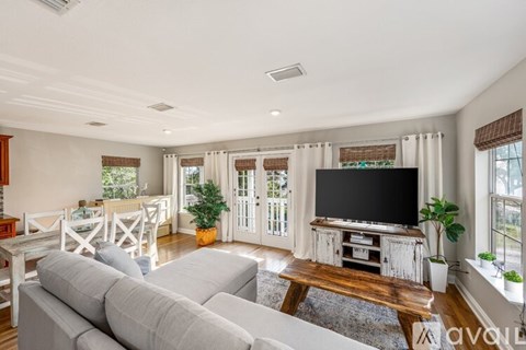 A living room with a grey sofa and a wooden coffee table.