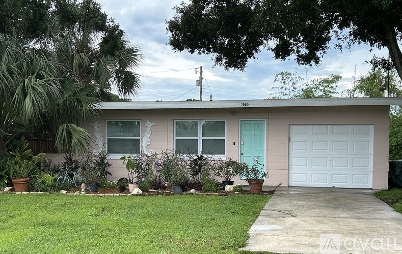 A house with a blue door and a white garage door.
