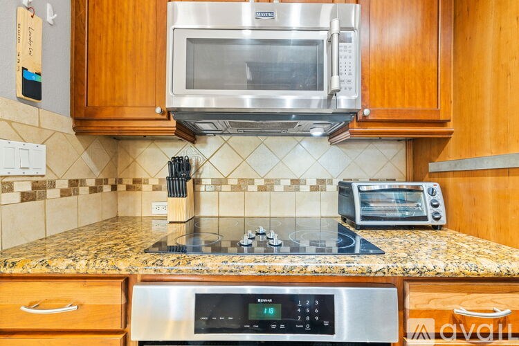 A kitchen with a stove top oven and microwave above it.