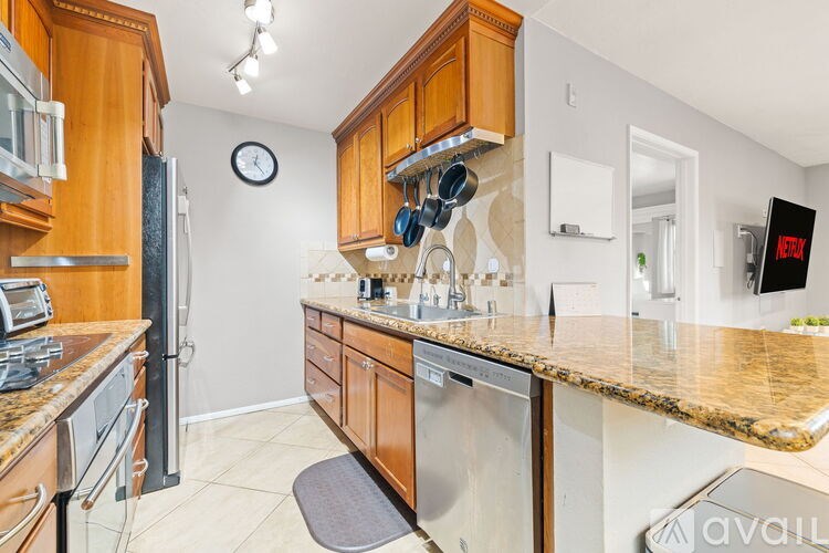 A kitchen with wooden cabinets and granite countertops.