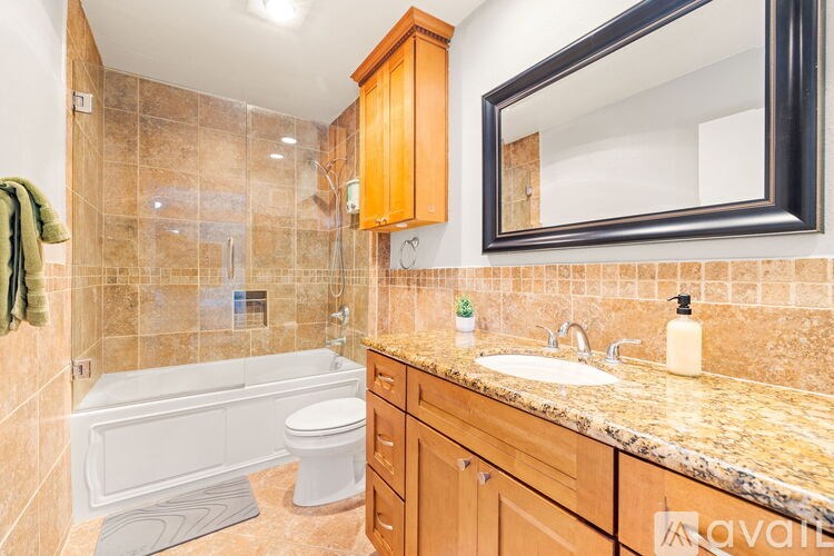 A bathroom with a tub, toilet, and sink.