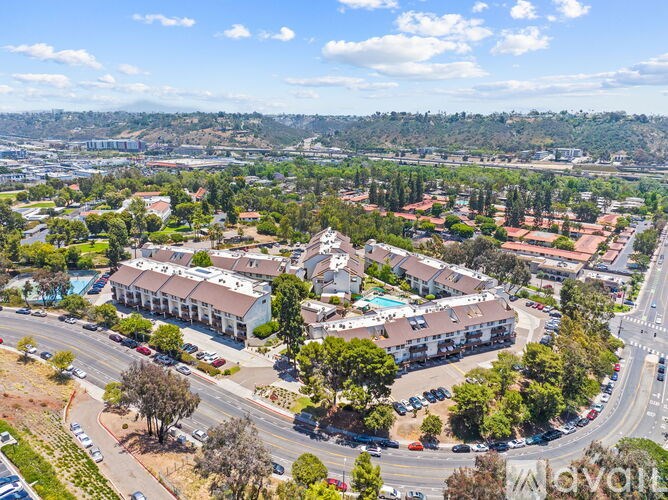 A bird's eye view of a residential area with a large building in the center.