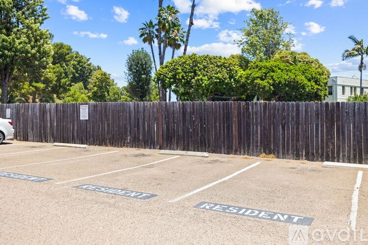 A parking lot with the word "RESIDENT" painted on the ground.