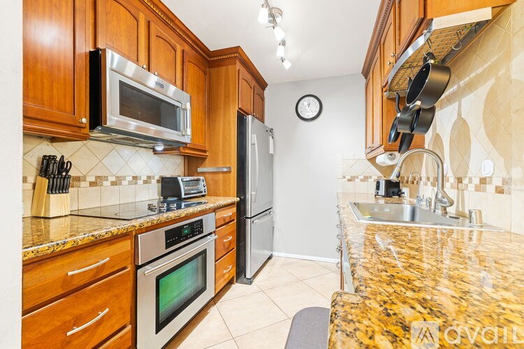 A kitchen with granite countertops and stainless steel appliances.