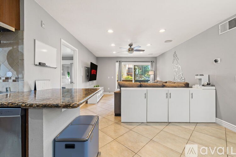 A kitchen with a marble countertop and a ceiling fan.
