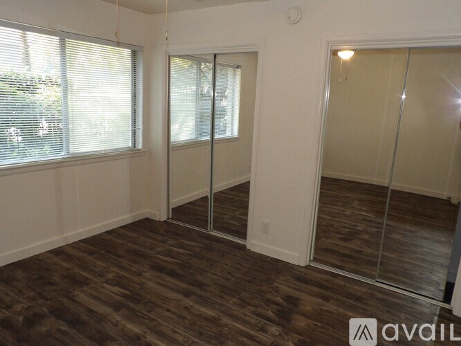 A room with a wooden floor and a glass door.