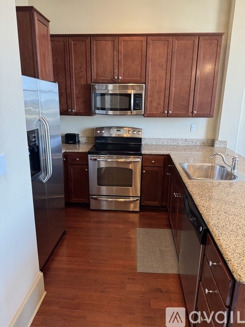 A kitchen with wooden cabinets and stainless steel appliances.