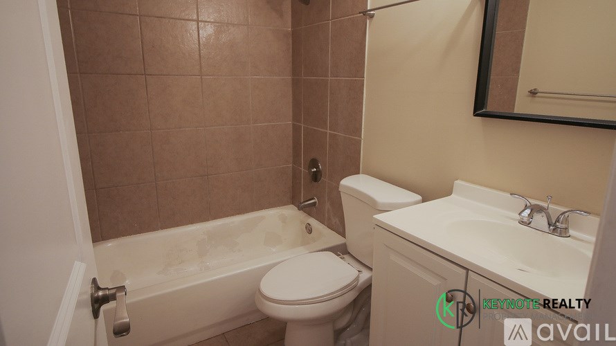 A bathroom with a toilet, sink, and bathtub.