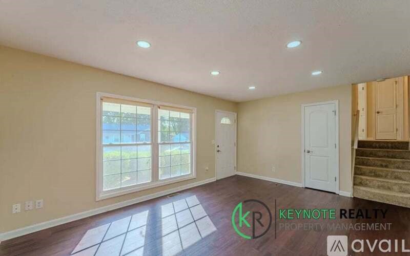 A room with a window and a door is available for rent.