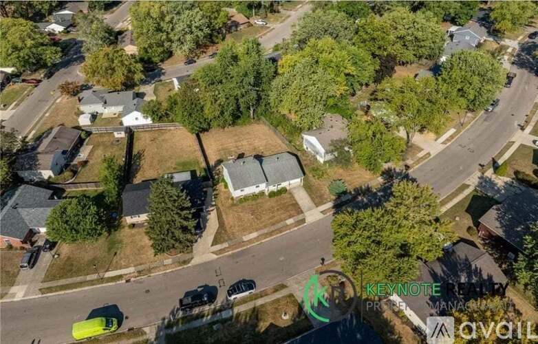 A bird's eye view of a residential area with houses and trees.