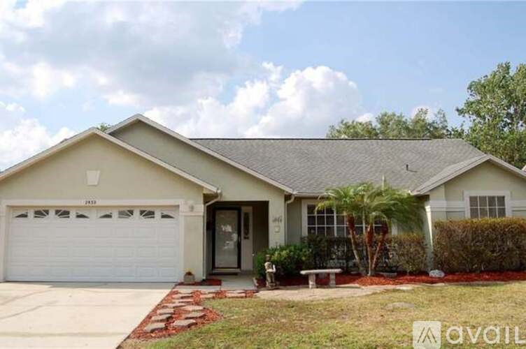 A house with a garage and a driveway in front.