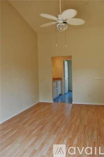 A room with wooden floors and a ceiling fan.
