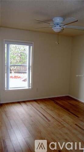 A room with wooden floors and a window.