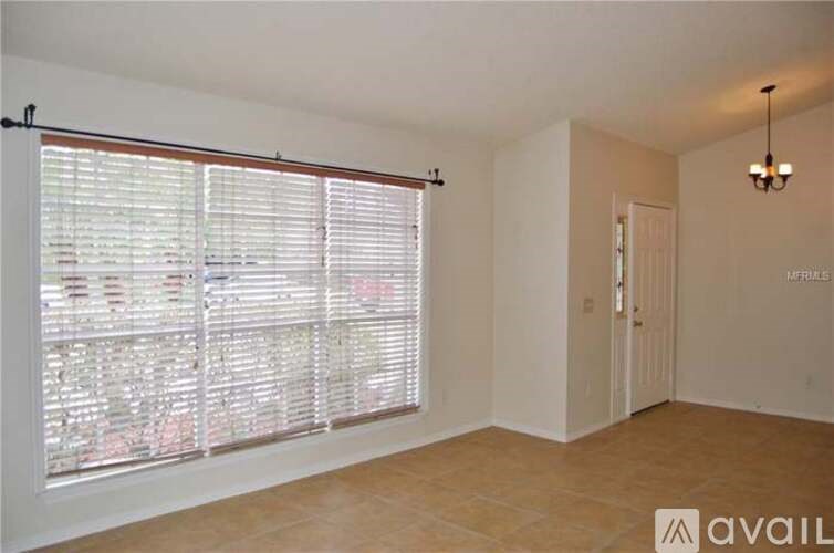 A room with a view of a street through the window.