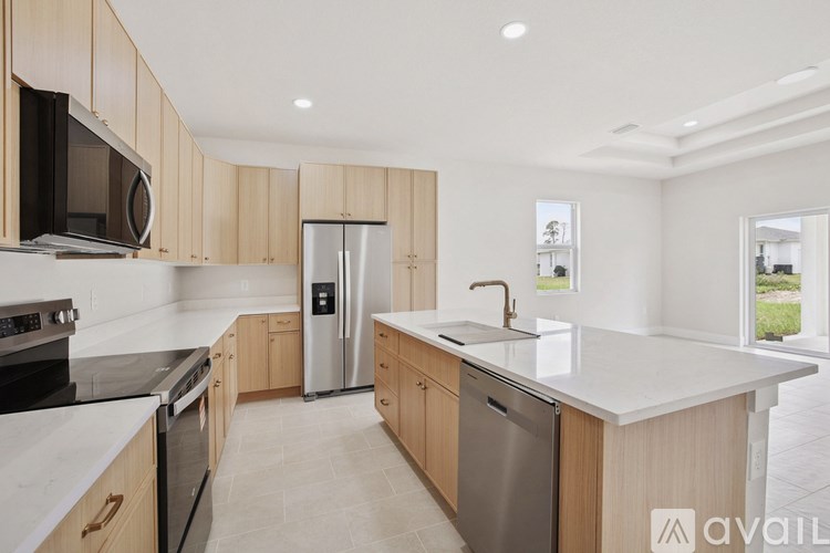 A kitchen with wooden cabinets and a stainless steel refrigerator.