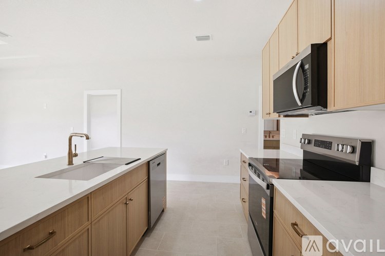 A kitchen with wooden cabinets and a white countertop.