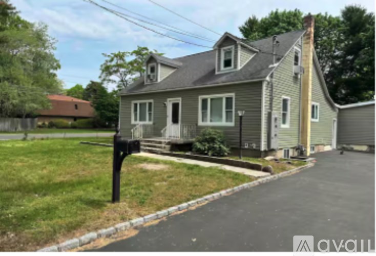 A house with a grey roof and a garage door is shown.