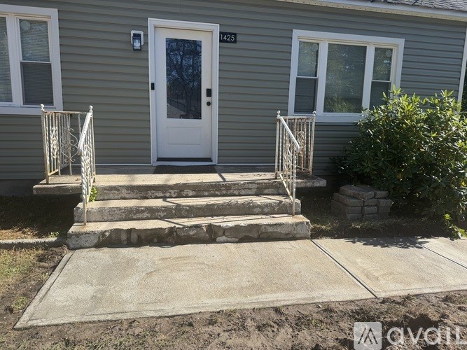 A house with a white door and a small porch.