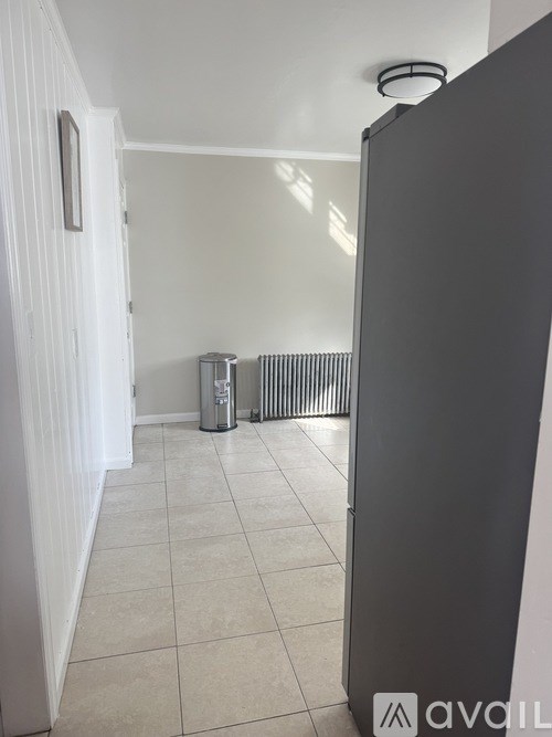 A room with a white door and a radiator.