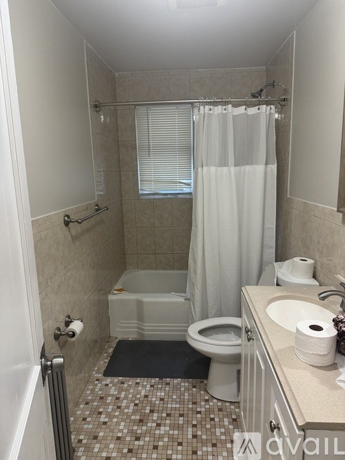 A bathroom with a toilet, sink, and bathtub.