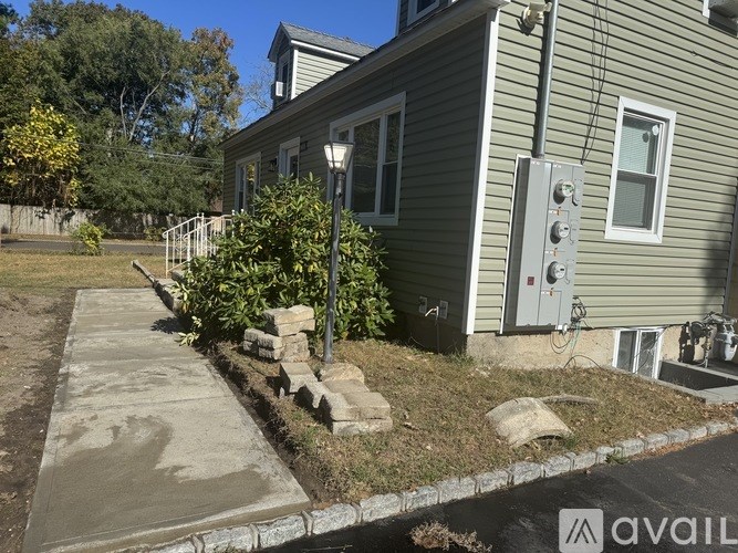 A house with a grey siding and a grey electrical box on the side.