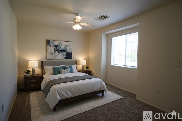 A bedroom with two beds and a ceiling fan.