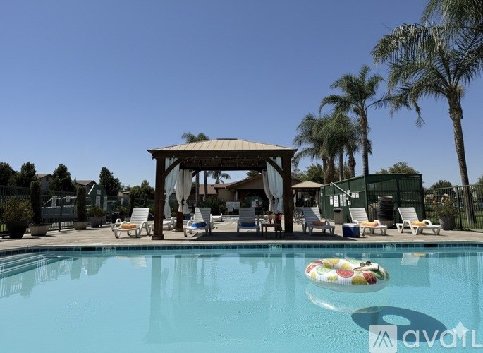 A pool with a floating fruit basket in the middle of it.