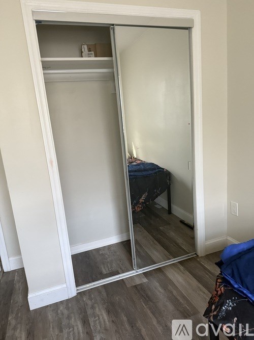 A bedroom with a bed and a wardrobe.