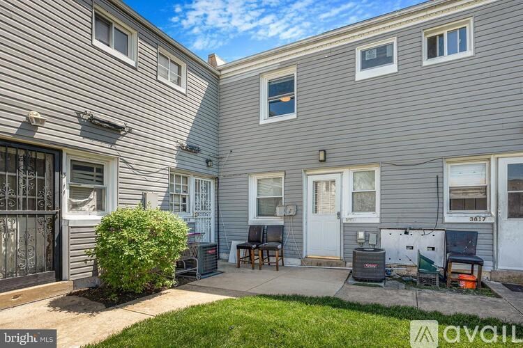 A grey house with a white door and windows.