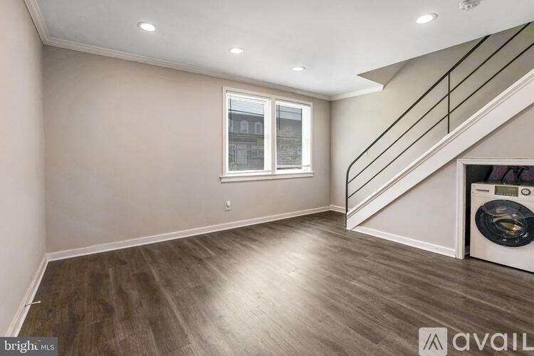 A room with a washing machine and a window.