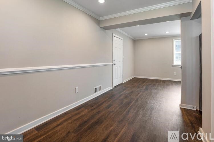A room with wooden floors and a white door.