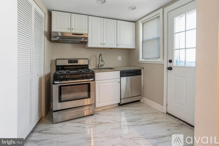 A kitchen with a stove, oven, and cabinets.