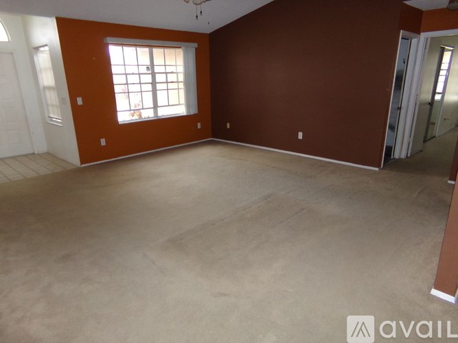 A room with brown walls and a window.