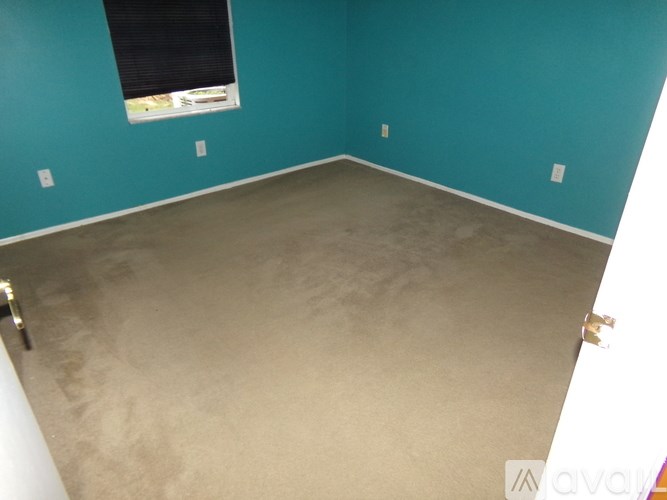 A room with a window and a wall with two lights.