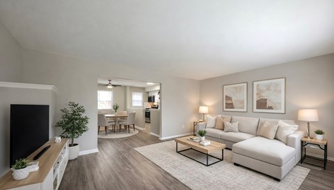 A bedroom with a bed, chair, and painting on the wall.