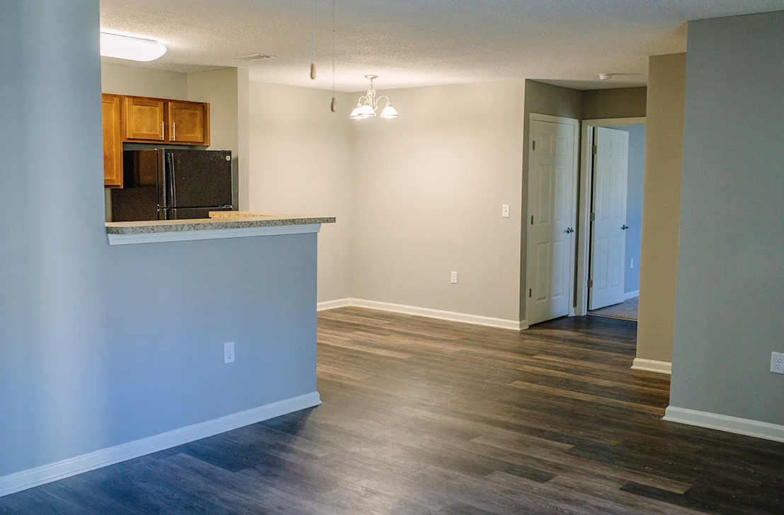 A kitchen area with a counter and microwave.
