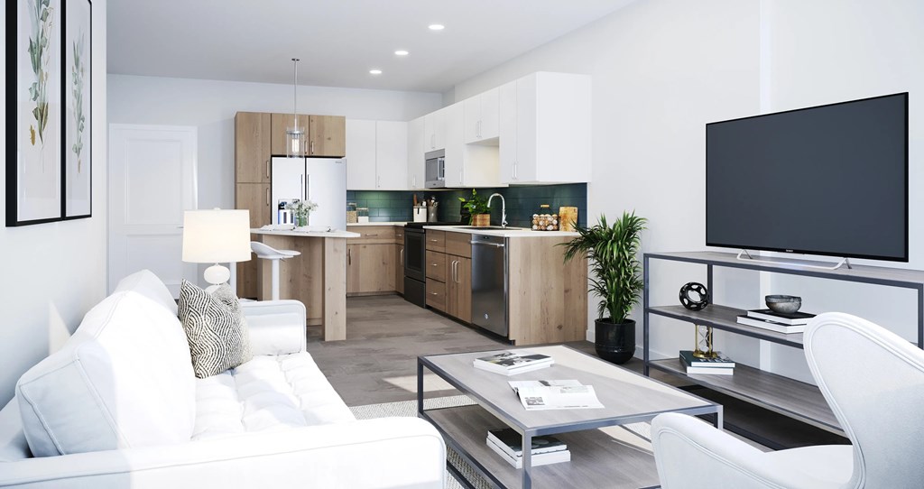 A modern living room with a white sofa and a television on the wall.