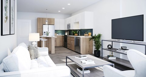 A modern living room with a white sofa and a television on the wall.